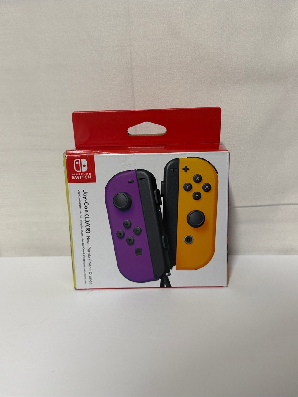 Nintendo Joy-Con Controllers in Purple and Yellow-Orange New Damaged Box